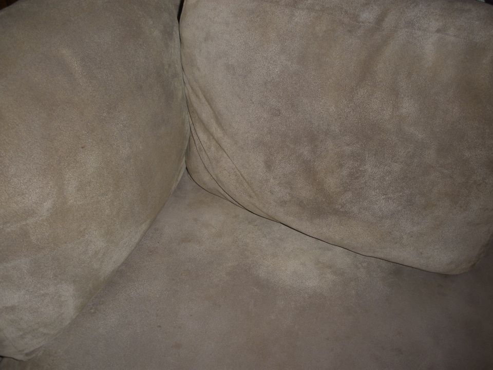 Tan sofa cushions with visible seams and texture. A watermark reads SUPERMOTORS.NET