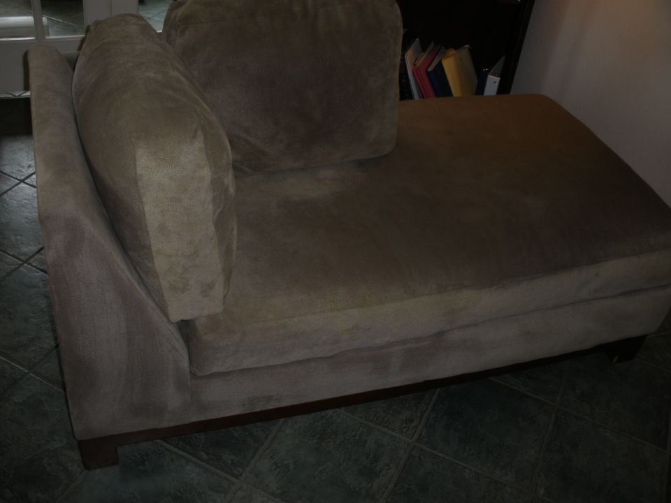 Brown fabric chaise lounge with a large back cushion and a separate armrest