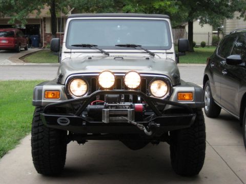 2005 Jeep Wrangler - Silver 2005 Jeep Wrangler equipped with PIAA lights and a winch, parked next to a black SUV.