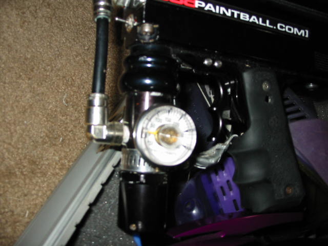 Paintball marker with air tank regulator and pressure gauge in a foam case