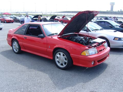 2007 Ford Mustang - A red 1987 Ford Mustang coupe is displayed with its hood open at an outdoor car show.