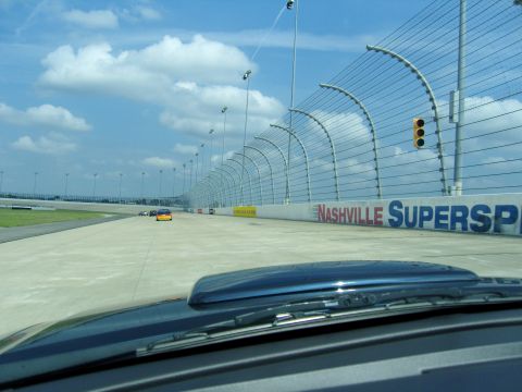 2007 Ford Mustang - A view from a vehicle on the track at Nashville Superspeedway, with other cars in the distance.