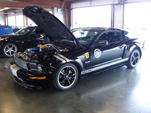 2007 Ford Mustang - Black 2007 Ford Mustang Shelby GT SC at a car show, hood open to reveal the engine.