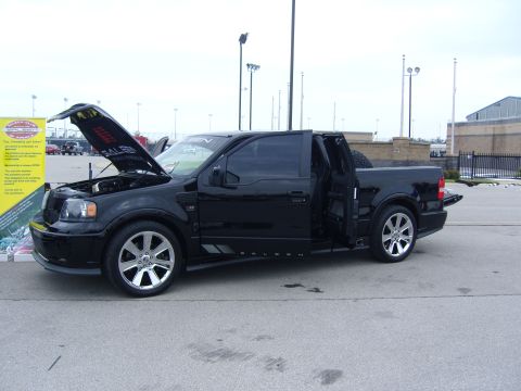 2007 Ford Mustang - A black Saleen F-150 pickup truck is displayed with its hood and doors open, revealing custom details.