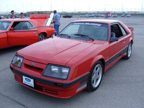 2007 Ford Mustang - A red Saleen Mustang is parked at an outdoor event with other cars visible.