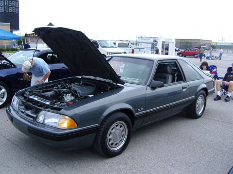 2007 Ford Mustang - A gray 1987 Ford Mustang 5.0 coupe is displayed with its hood open at a car show.