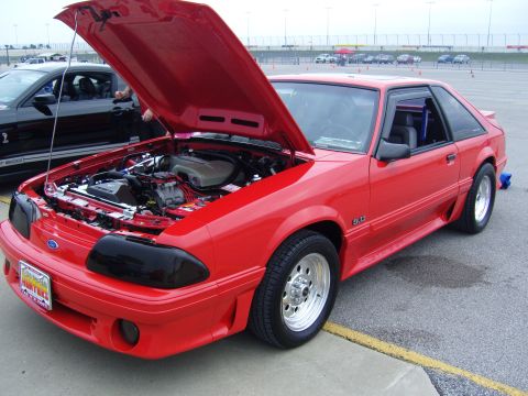 2007 Ford Mustang - A red 1987-1993 Ford Mustang GT 5.0 is displayed with its hood open, revealing the engine compartment.