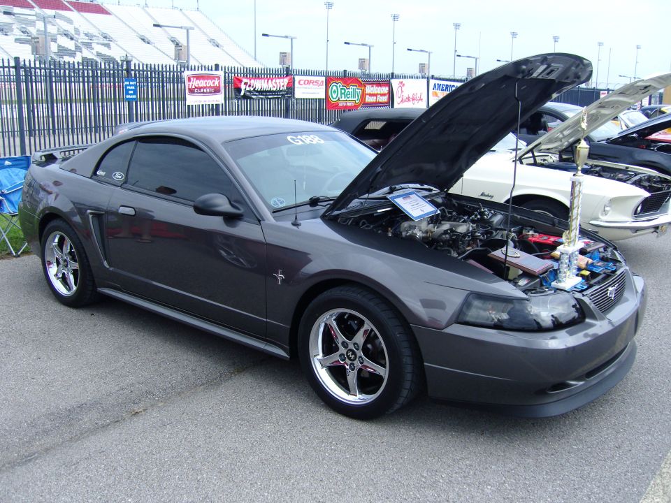 Dark gray 2007 Ford Mustang with hood open, trophy on display