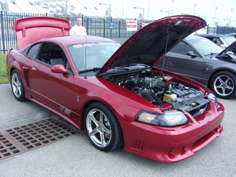 2007 Ford Mustang - A red Saleen Mustang is displayed with its hood and trunk open, revealing the engine compartment.