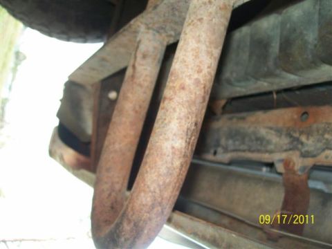 1979 Ford F-150 - This photo shows the underside of a vehicle, focusing on the exhaust system and frame components.