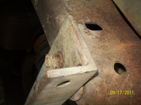 1979 Ford F-150 - Close-up of a rusted metal frame bracket and bolt, showing signs of wear and age.
