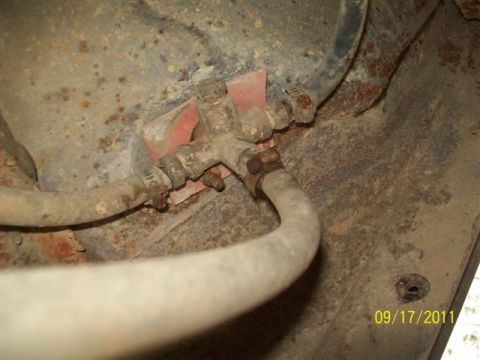 1979 Ford F-150 - Close-up of a fuel line valve and hoses on a rusty vehicle undercarriage, dated 09/17/2011.