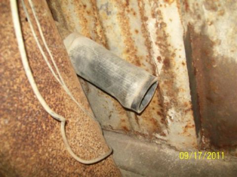 1979 Ford F-150 - Undercarriage view showing an exhaust pipe and significant rust. Date: 09/17/2011.