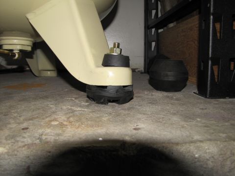 1993 Ford F-250 - Rubber and metal mounting feet are visible on an air compressor, attached to a concrete floor.