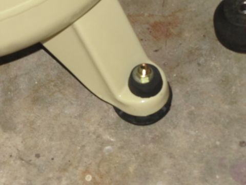 1993 Ford F-250 - A close-up view of a vehicle's suspension component, showing a rubber bushing and bolt assembly.