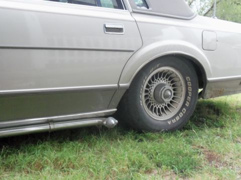 2000 Mercury Grand Marquis - The side of a Lincoln Town Car is shown, a vinyl roof and a Cooper Cobra tire.