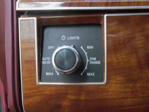 2000 Mercury Grand Marquis - A close-up of a car's interior dashboard shows a rotary knob for controlling interior lights and their dimming range.