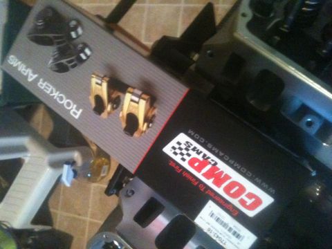1993 Ford Bronco - Close-up of COMP Cams rocker arms and other engine components, suggesting automotive performance parts.
