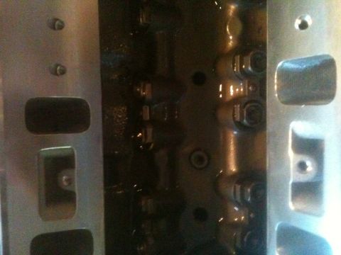 1993 Ford Bronco - This is a close-up view of an engine's cylinder head, showing internal components and bolt heads.