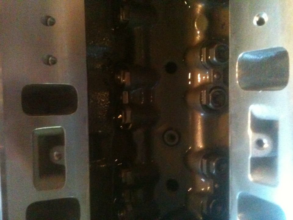 close-up of engine cylinder head with bolts visible
