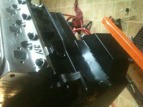 1993 Ford Bronco - Close-up view of an engine block and intake manifold, likely in a workshop setting.