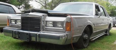 2000 Mercury Grand Marquis - This older model Lincoln Town Car is parked outdoors with its hood open, revealing the engine bay.