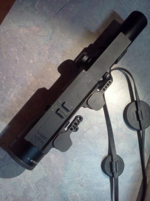 1996 Ford Bronco - A close-up view of a gun receiver with visible markings and a strap.