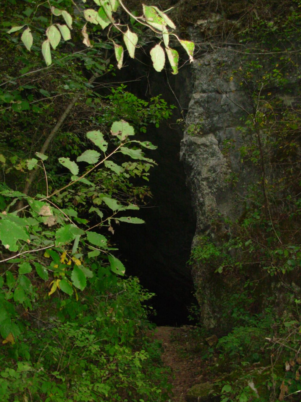 There's a tiny parking area barely big enough for 4 cars & some 4-wheelers, with a narrow trail leading around the hillside to the mouth of the cave.  It wasn't blowing enough today to feel any draft, but the locals told us it's sometimes strong enough to hear in the parking area.