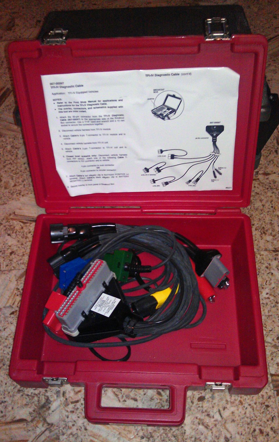 Red case with diagnostic cables and instructions inside