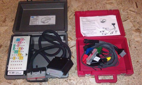 1990 Ford Bronco - Two open cases display various automotive diagnostic tools, cables, and connectors, suggesting a repair or testing kit.