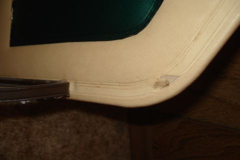 1979 Ford Bronco - Detail of the interior trim, showing wear and tear on the beige material.