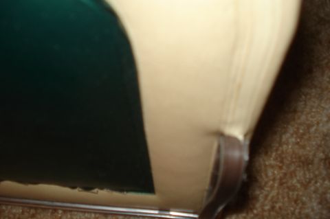 1979 Ford Bronco - Close-up of interior upholstery and a dark green panel, with a brown strap.