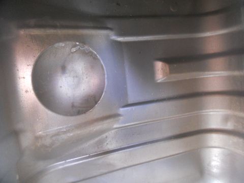 1991 Ford Bronco - Metal casting detail with a circular recess and parallel ridges.