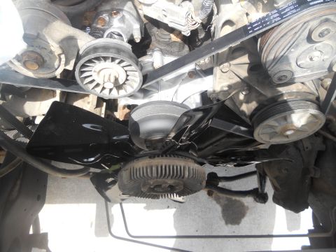 1991 Ford Bronco - Engine bay components including fan, belts, and pulleys are visible in this close-up shot.
