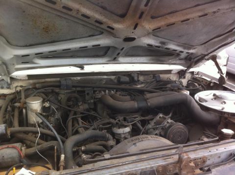 1992 Ford Bronco - The engine bay of a vehicle, showing various components and wiring.