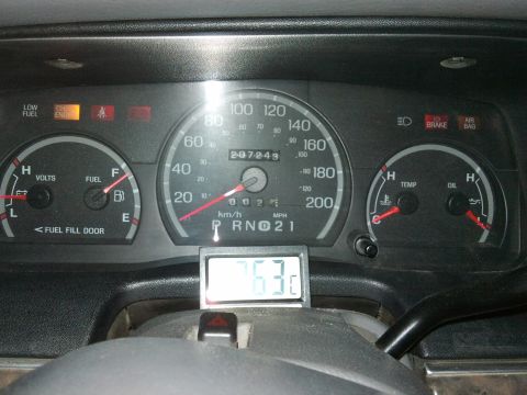 1998 Ford Crown Victoria - Dashboard view of a 1998 Ford Crown Victoria, showing gauges and a digital temperature display.