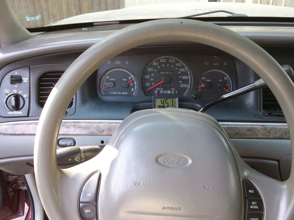 Ford steering wheel and dashboard gauges, shows 45.1 miles per gallon
