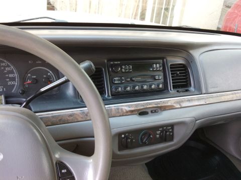 1998 Ford Crown Victoria - Interior view of a 1998 Ford Crown Victoria, highlighting the dashboard and center console details.