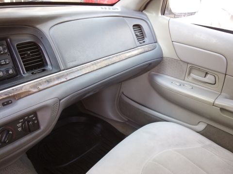 1998 Ford Crown Victoria - Interior view of a 1998 Ford Crown Victoria, showing the dashboard and passenger side door panel.