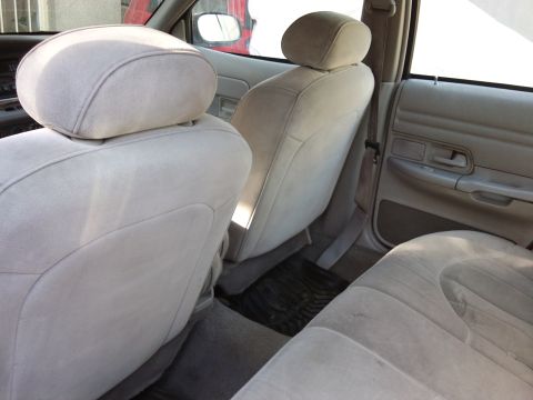 1998 Ford Crown Victoria - The interior of a 1998 Ford Crown Victoria shows light tan cloth seats and door panels.