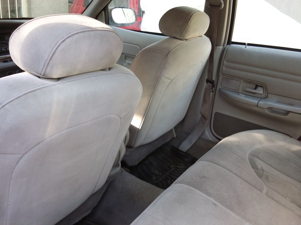 1998 Ford Crown Victoria interior with light tan cloth seats and door panels