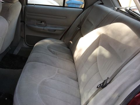 1998 Ford Crown Victoria - The interior of a car is shown, focusing on the rear seating area and door panel.