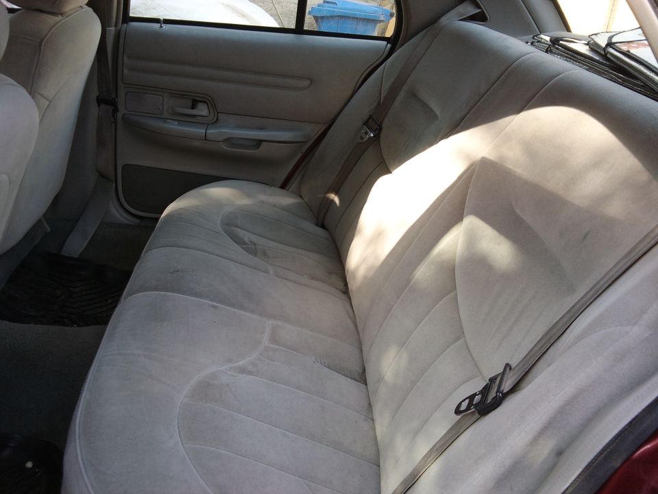 Car interior with tan cloth rear seats and door panel