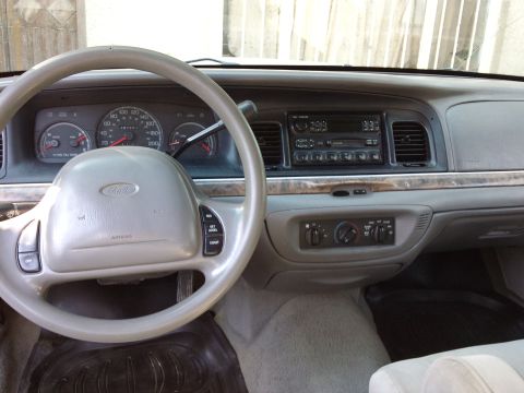 1998 Ford Crown Victoria - Interior view of a 1998 Ford Crown Victoria, highlighting the dashboard and driver's controls.