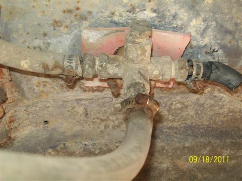 1979 Ford F-150 - Close-up of a rusty fuel filter housing with hoses attached, dated 09/18/2011.