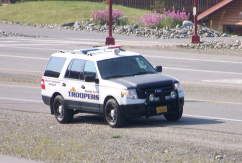 2006 Ford F-150 - Alaska State Trooper SUV, likely a Ford Expedition, is parked on the side of the road.