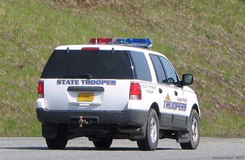 2006 Ford F-150 - Rear view of a white Ford Expedition SUV marked as "STATE TROOPER" with a light bar on the roof.