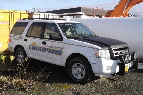 2006 Ford F-150 - This white SUV, marked as "Alaska State Troopers," features a bull bar and roof rack, suggesting it is equipped for duty.