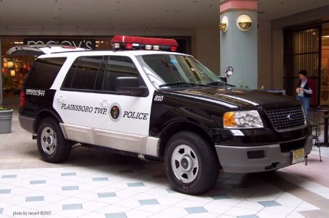 2006 Ford F-150 - Police SUV with 'PLAINSBORO TWP POLICE' markings parked indoors near a Macy's entrance.