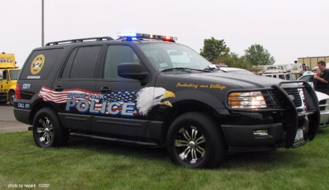 2006 Ford F-150 - Stone Park Police SUV, likely a 2006 Ford Expedition, features patriotic graphics and emergency lights.